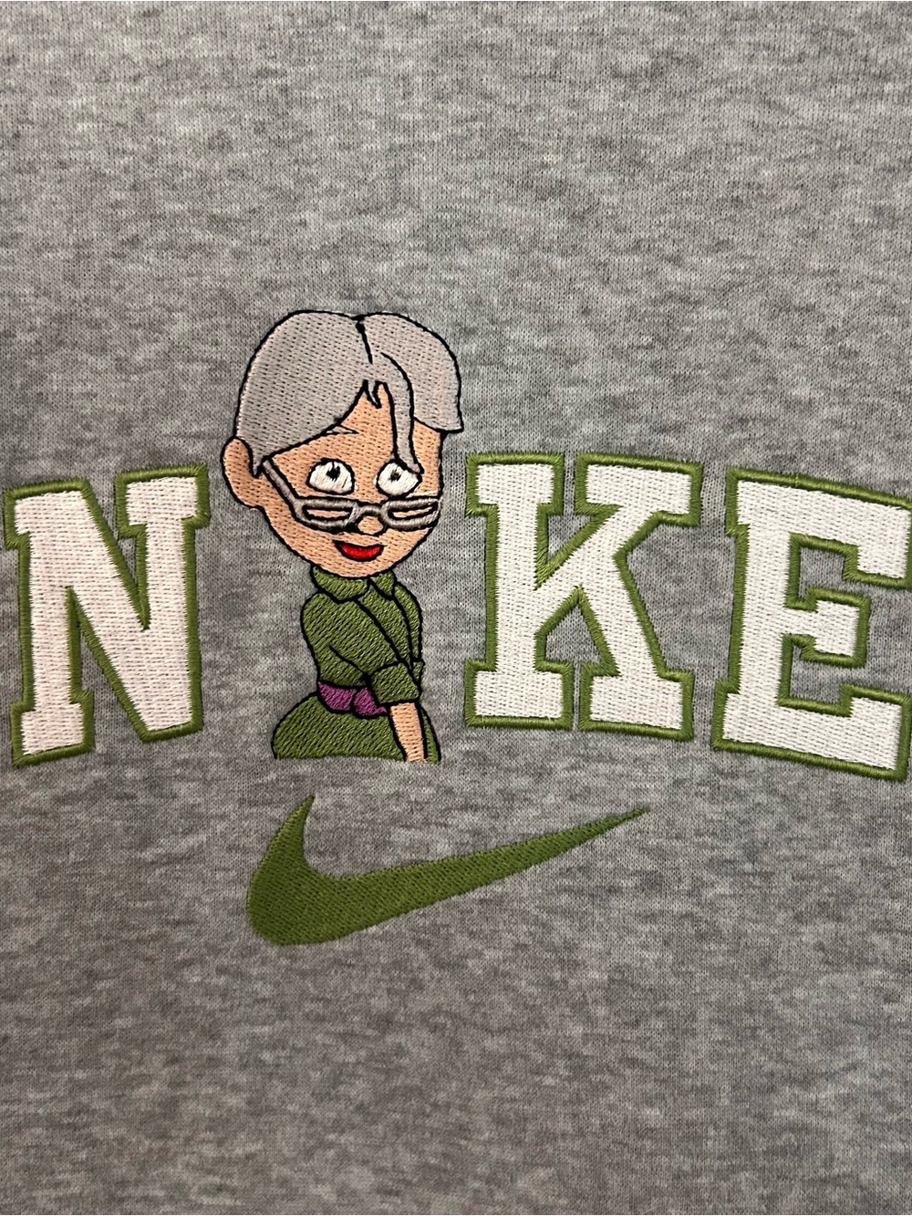 Nike Gray Sweatshirt with Green Accents and Cartoon Character